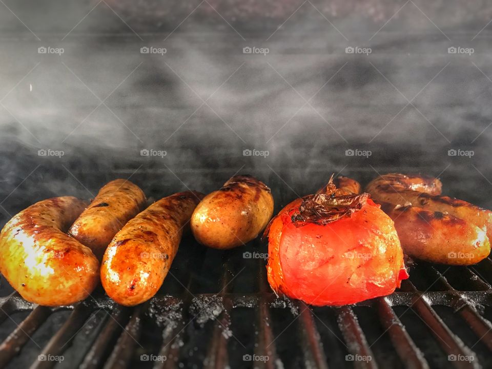 Grilled Tomato and Sausages.. Smoke trapped under the hood of the griller. Smells and tastes good.. hmmm....