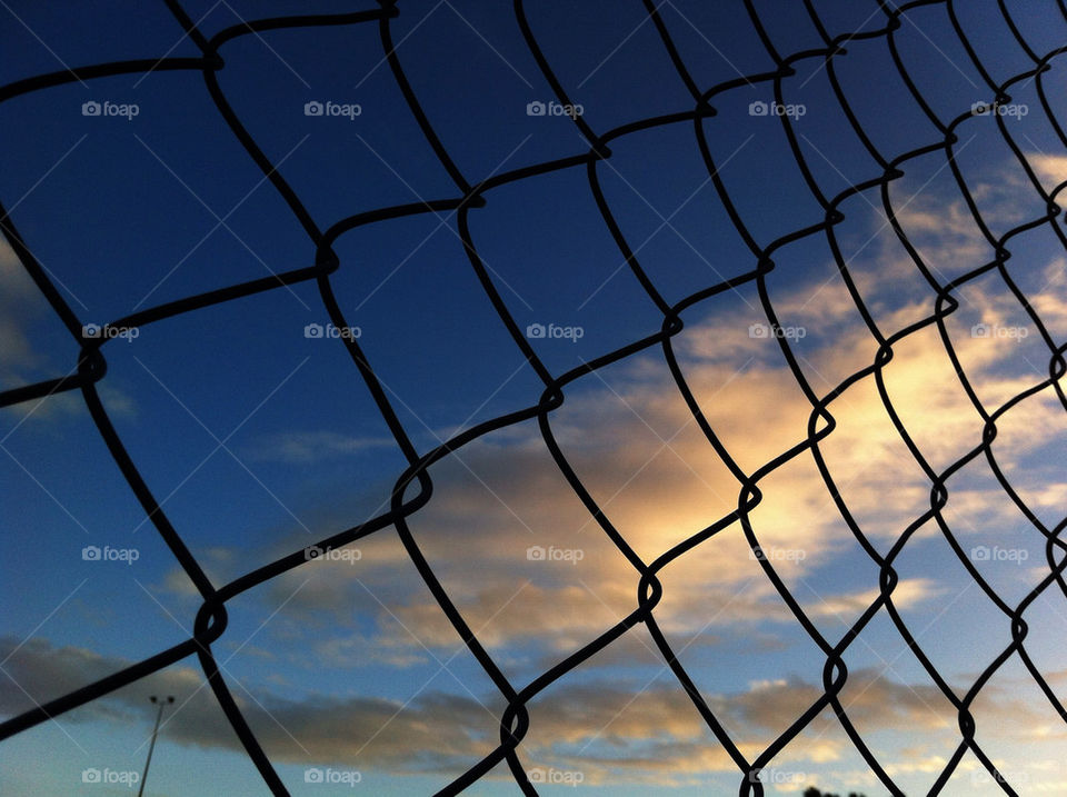 Clouds behind the fence