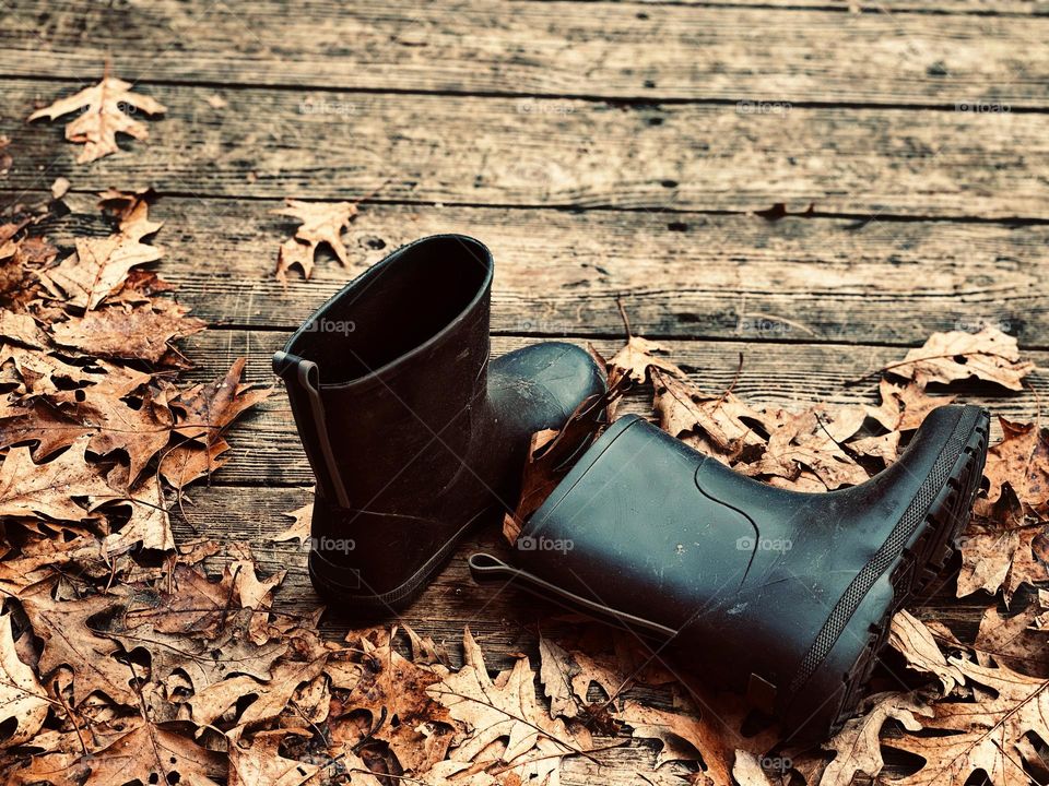 A very Fall day; Kids boots kicked off on the front porch in a pile of leaves