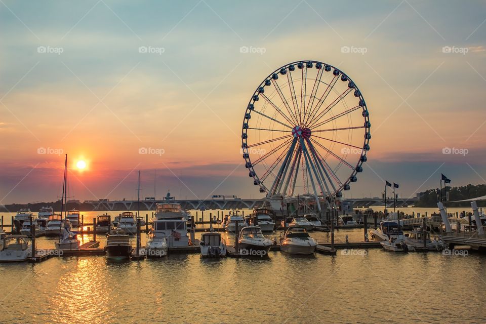 Harbor with sunset and ferris wheel 