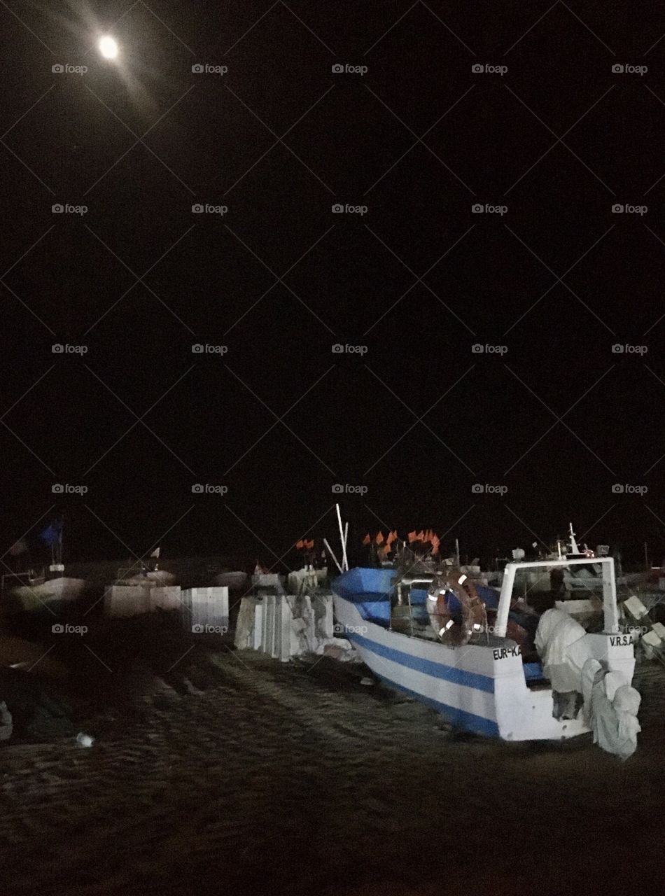 Fisherman boat by the moon