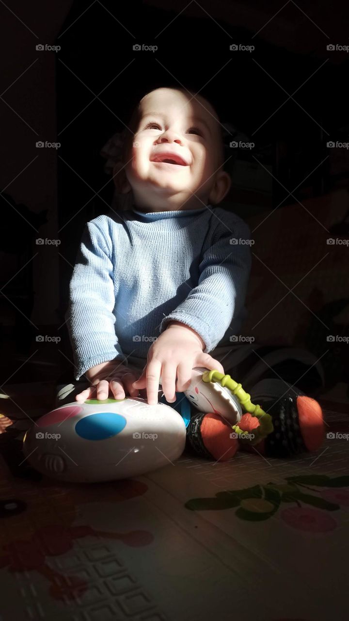 baby sits in a beam of light