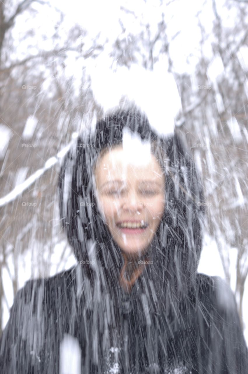 Snow. Girl throws snow