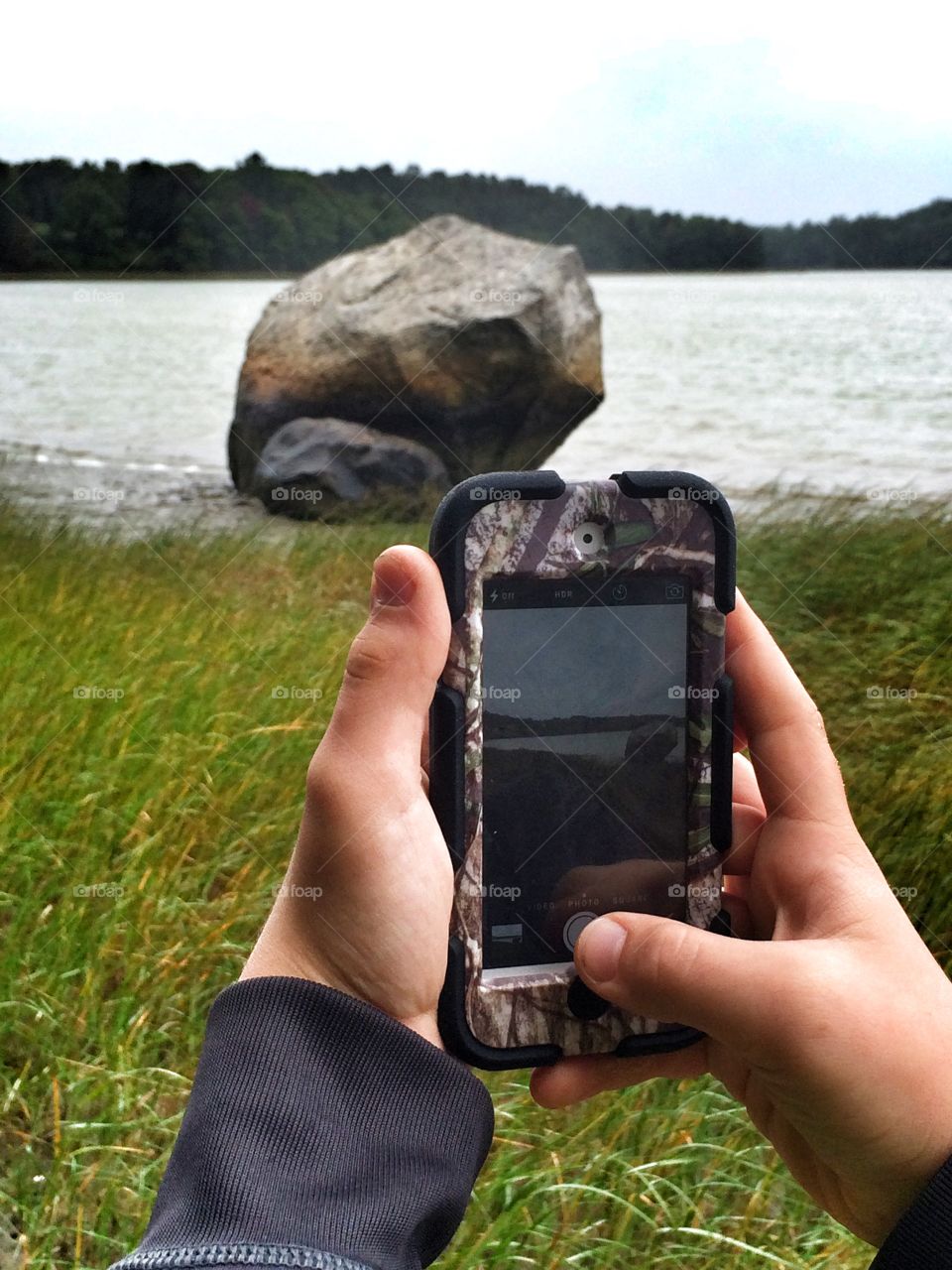 Boy taking photo with iPhone 