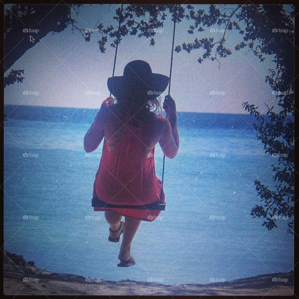 Swinging towards the sea . A swing on gili T indonesia. Beautiful and peaceful swinging and staring at the ocean