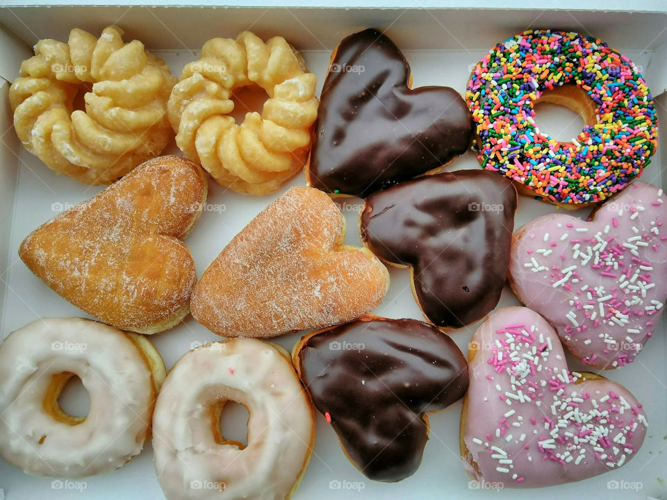 Box Of Assorted Donuts In A Variety Of Shapes And Flavors