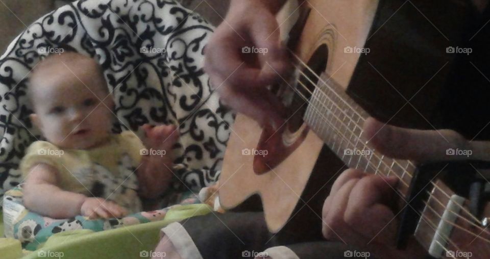 Singing with Daddy. she loves listening to him play.