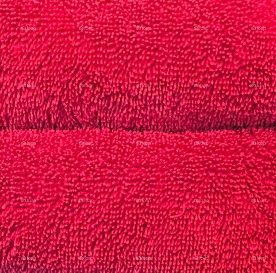 Red towels folded stacked closeup background image