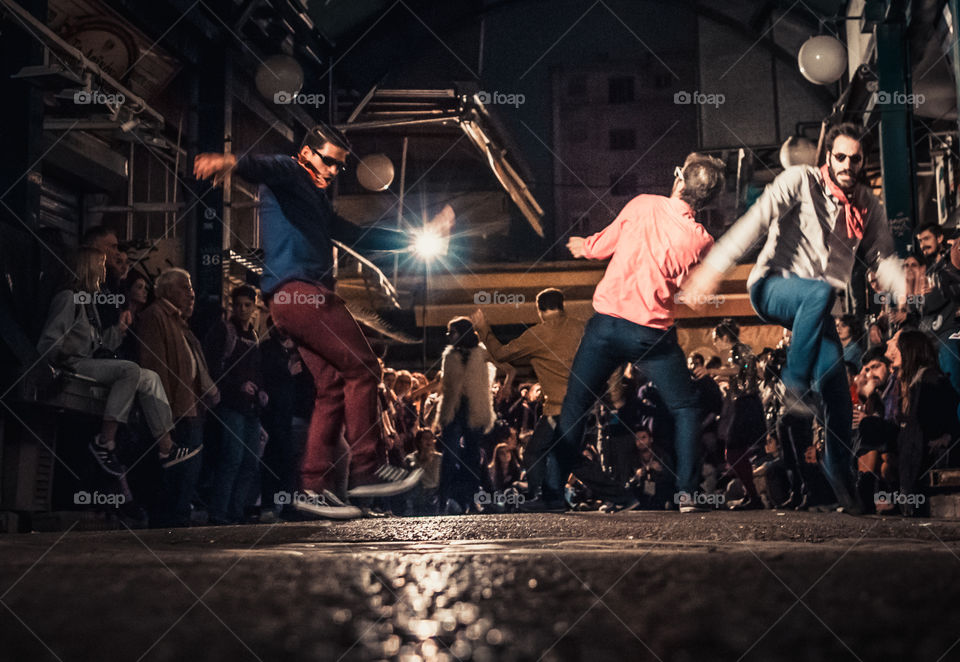 Street Dancing In The Night With Crowd Of People Watching
