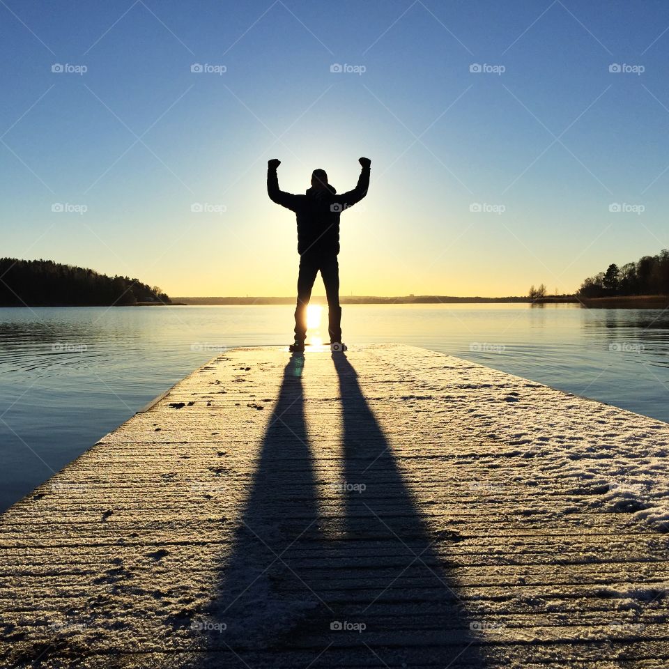 Silhouette of man stand on pier