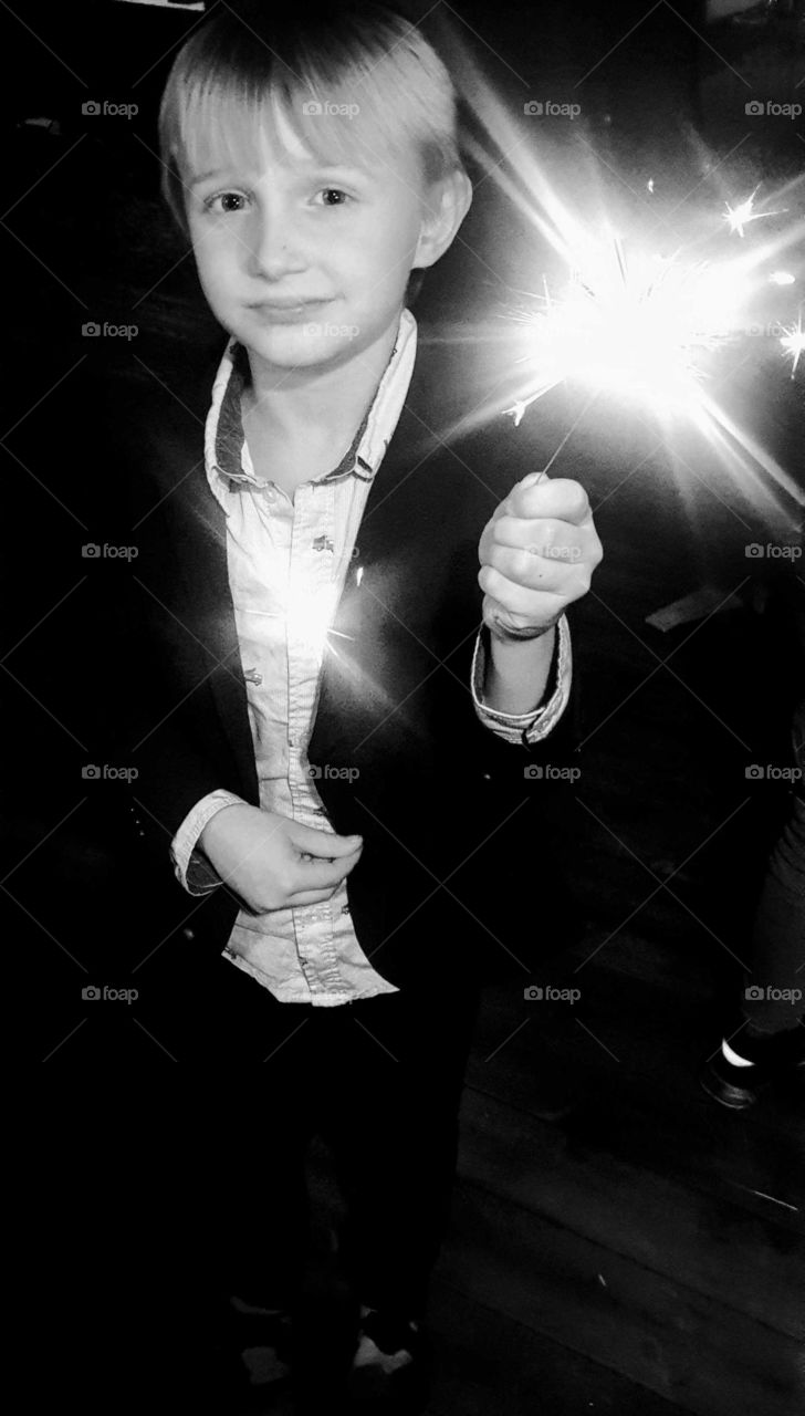 Boy with sparkler on New year's eve