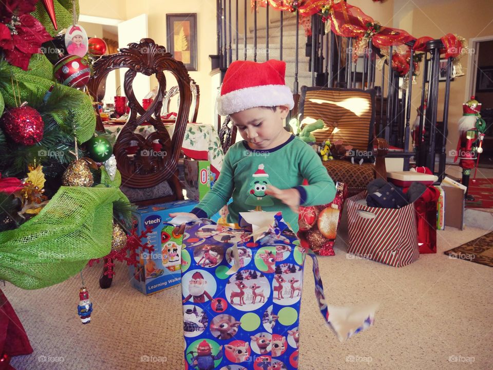Little boy opening Christmas gift