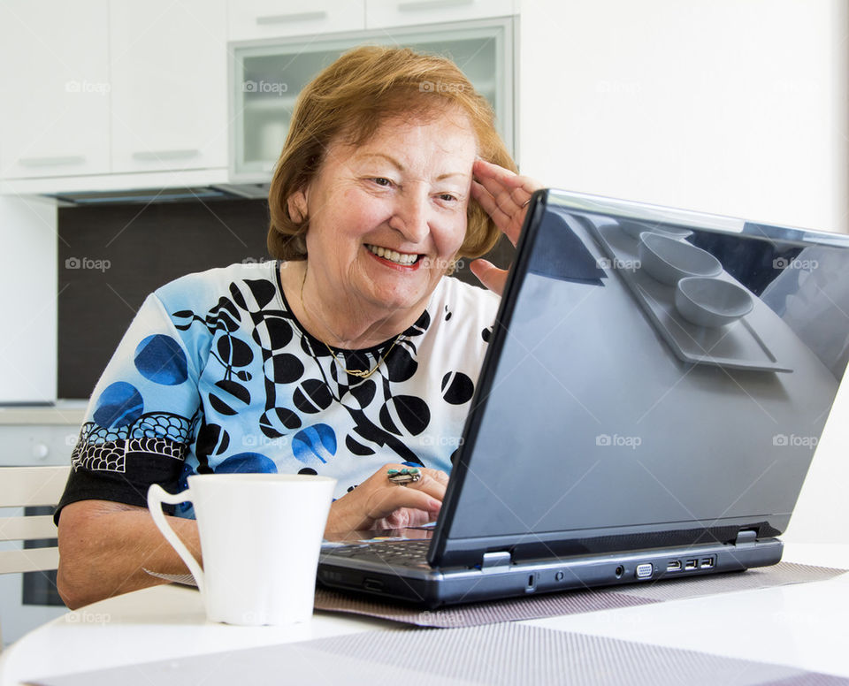 grandmother smiling at computer