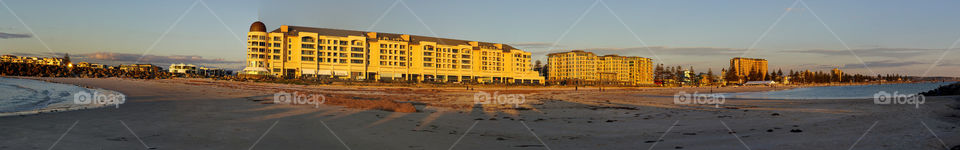 Glenelg panorama of beach. Panoramic shot if buildings at sunset and beach scenes ar Glenelg beach in Adelaide. 