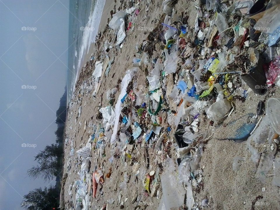dirty beach full of rubbish,trash . sad reality 