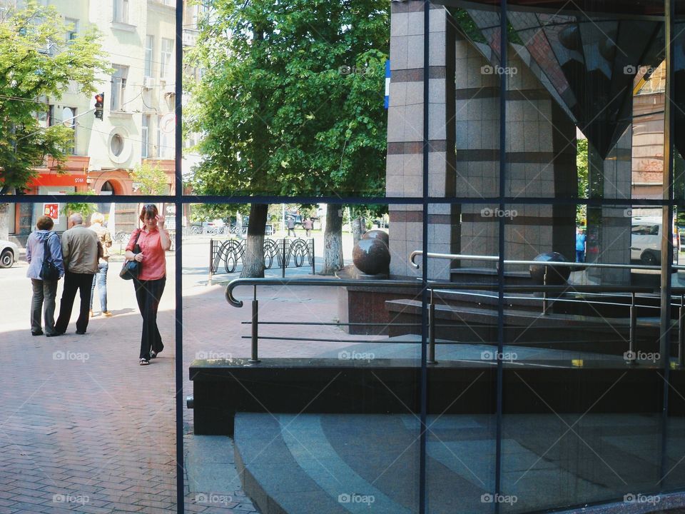 an incredible reflection of the street in a building window