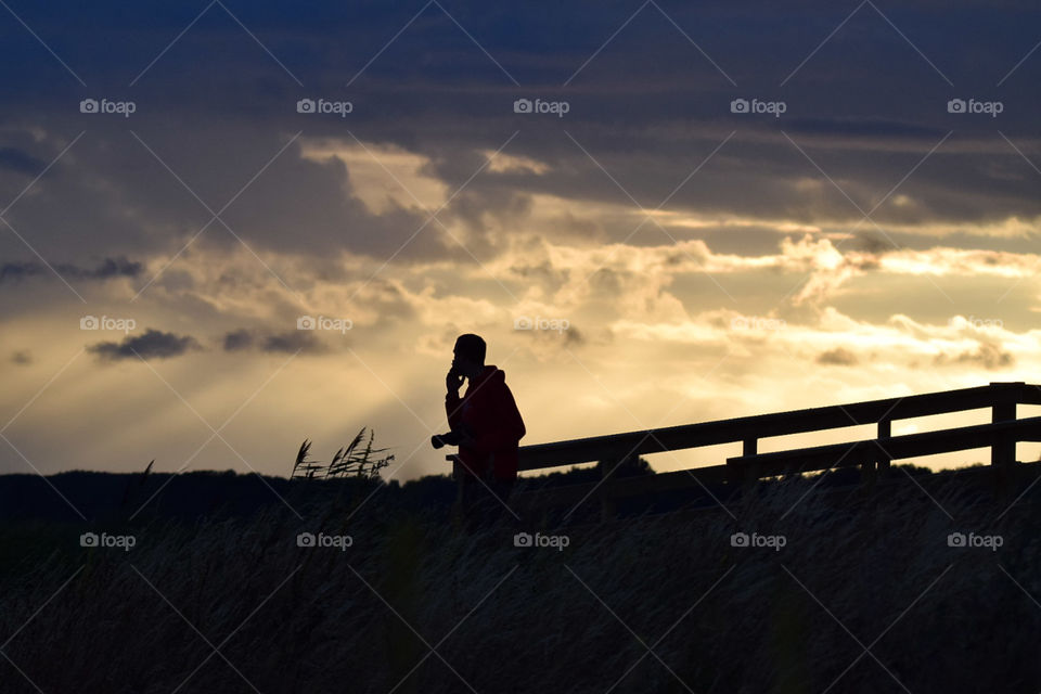 fotograf och fågelskådare vid kvismaren i solnedgång
