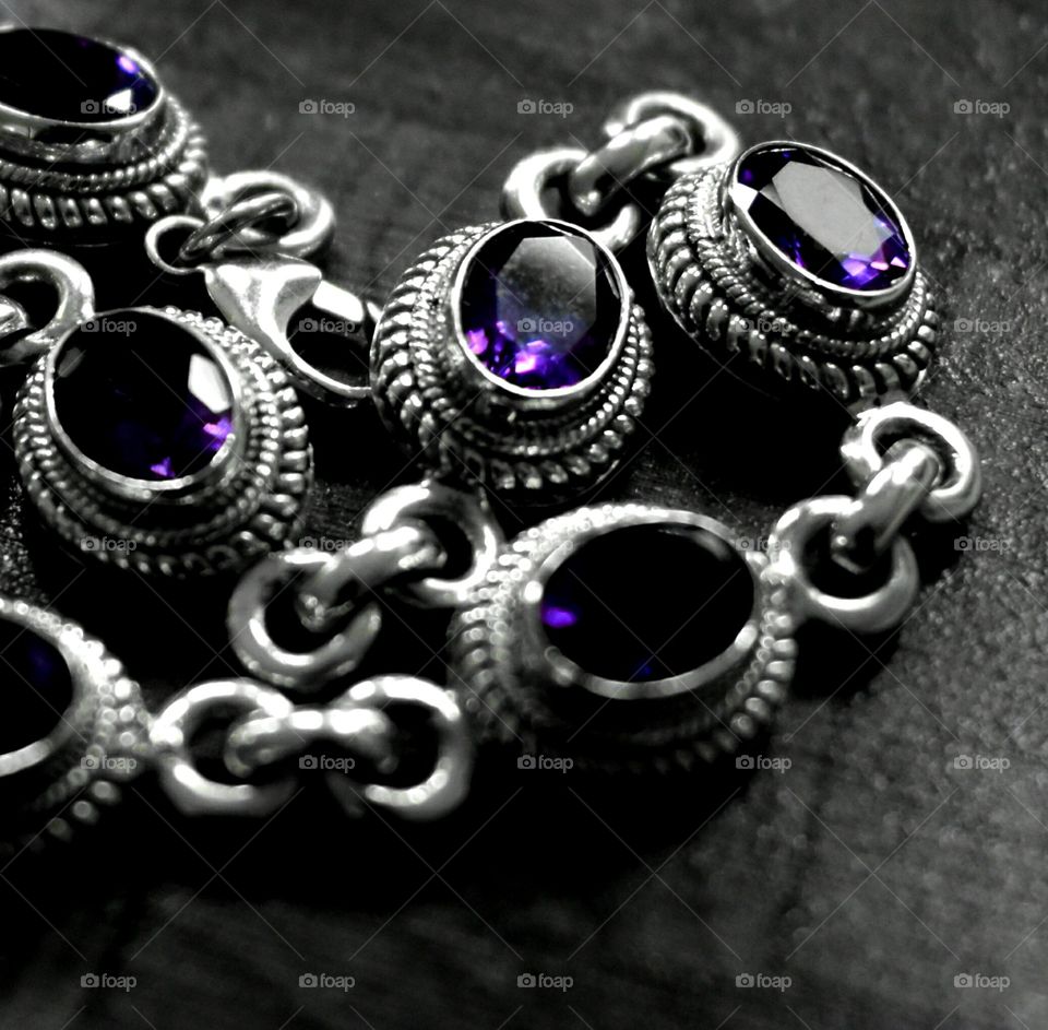 purple jewelry silver close up Emerald Sapphire ornate precious stones close up