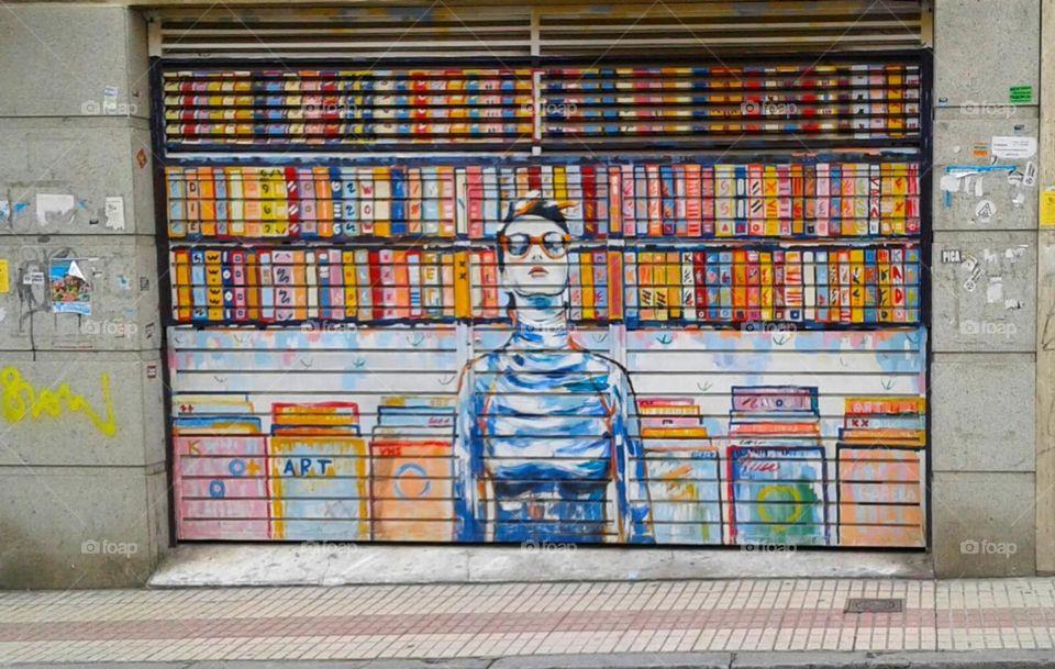 Visual Street Art: young woman with colorful book shelves and files
