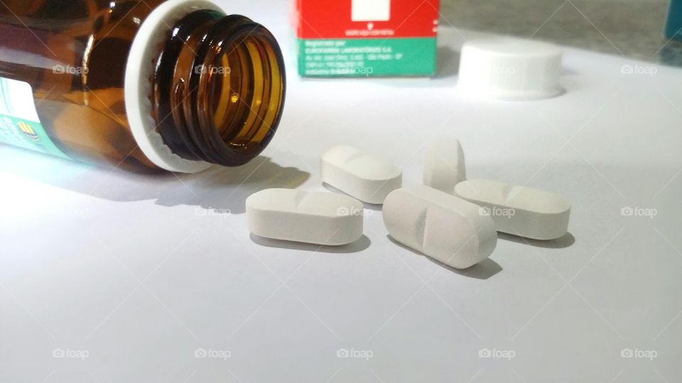 Pills spilling out of pill bottle