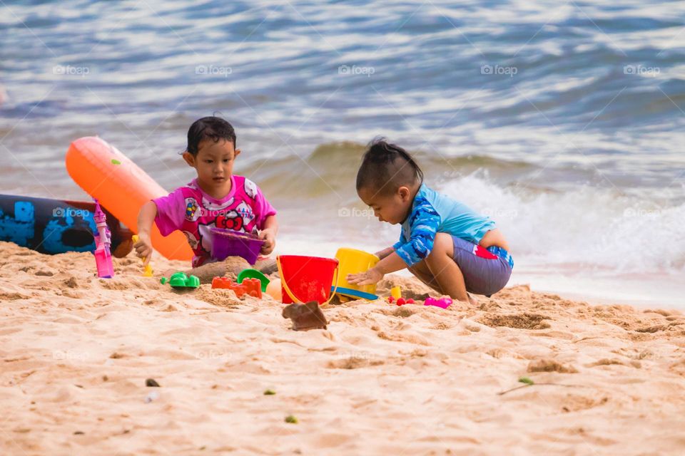 children playing on the beach in summer.