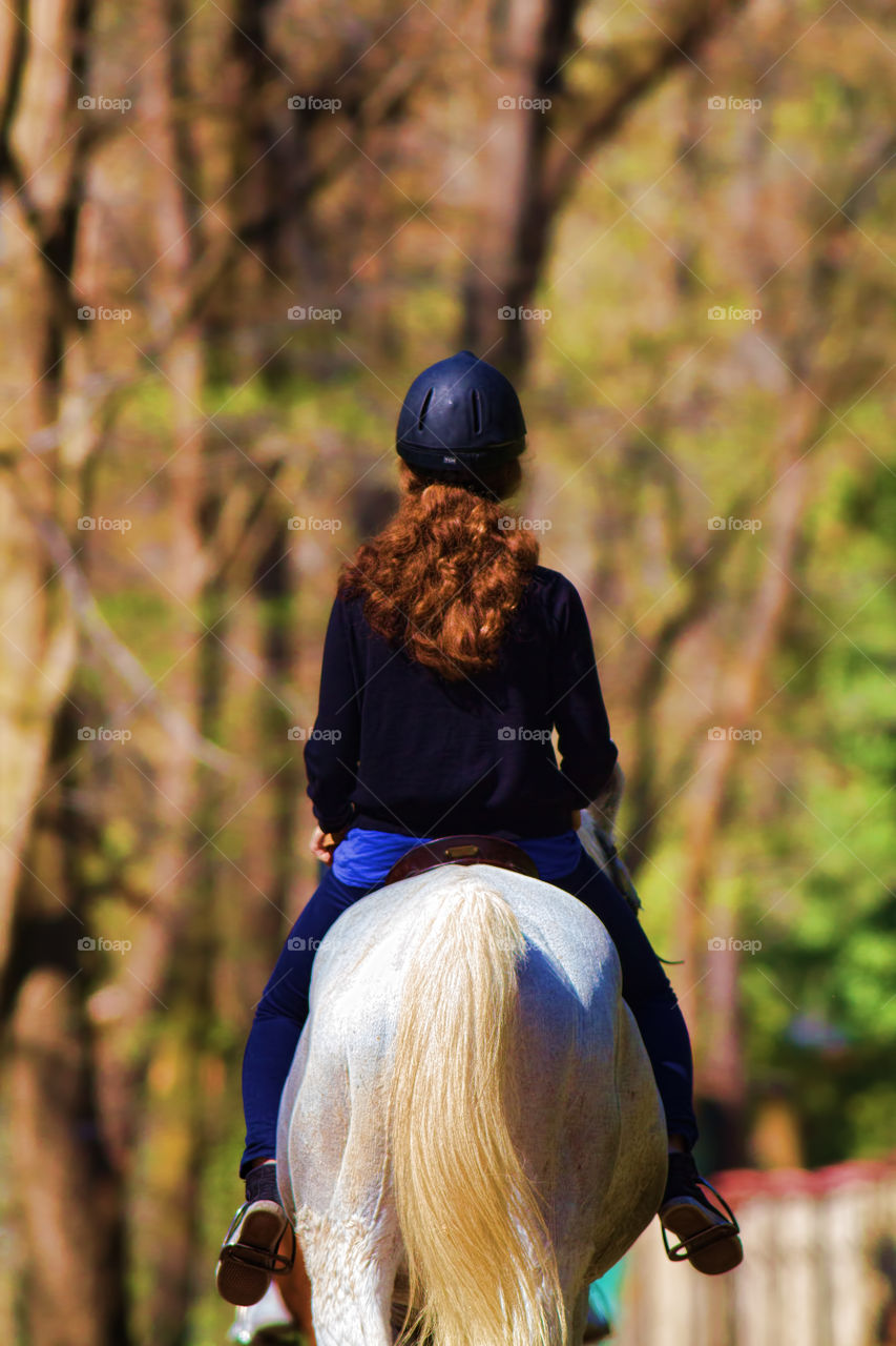 red-haired girl on a white horse