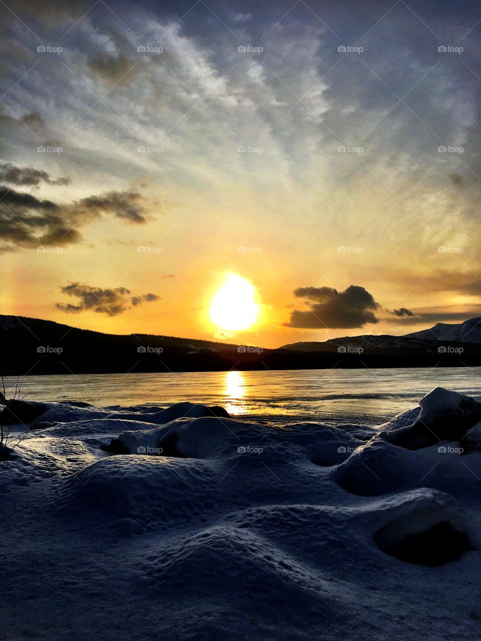 Sunset on icy lake 