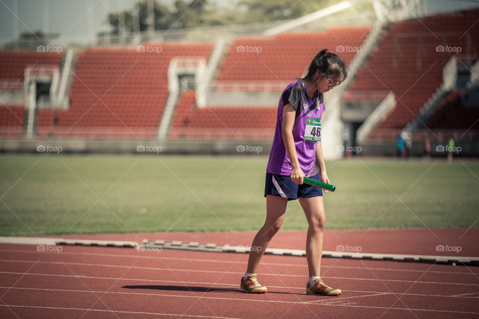 Athletic athlete girl in the track for the race