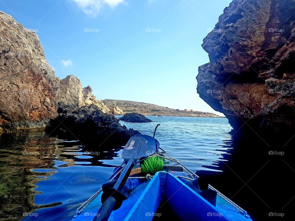 best of mother nature. kayaking in the blue Mediterranean sea off the rocky coast of malta