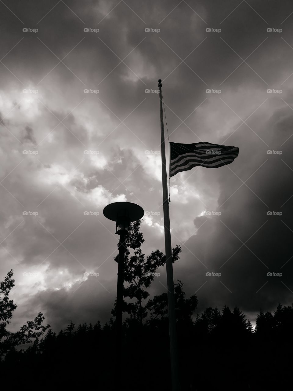 Flag with storm clouds behind