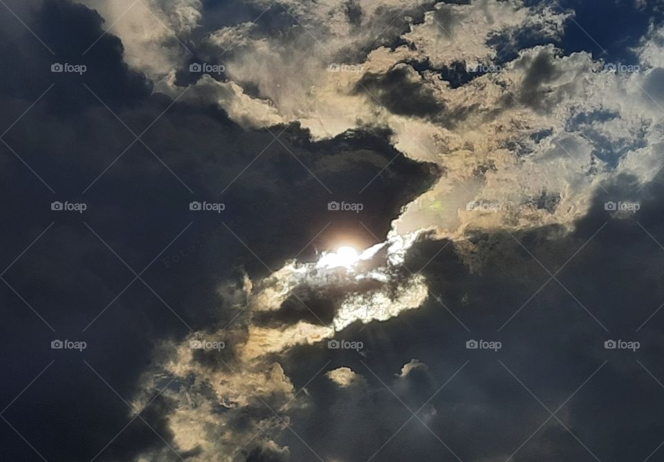 sunset through clouds,clouds,sunlight,sunshine,shining,reflection,sunset,landscape,summer, colorful,sky,cloudy