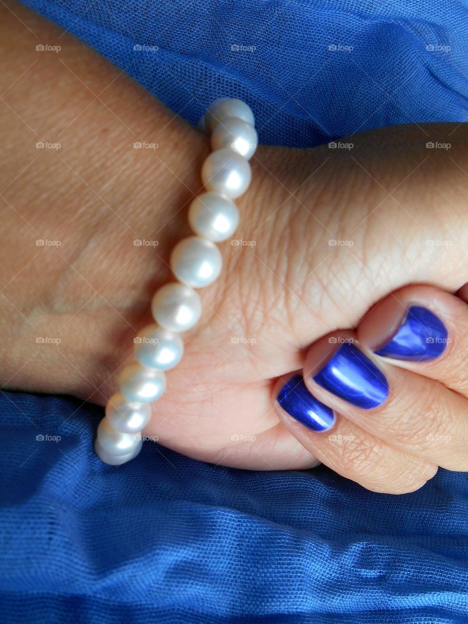 female hand with pearls bracelet, beautiful accessories woman