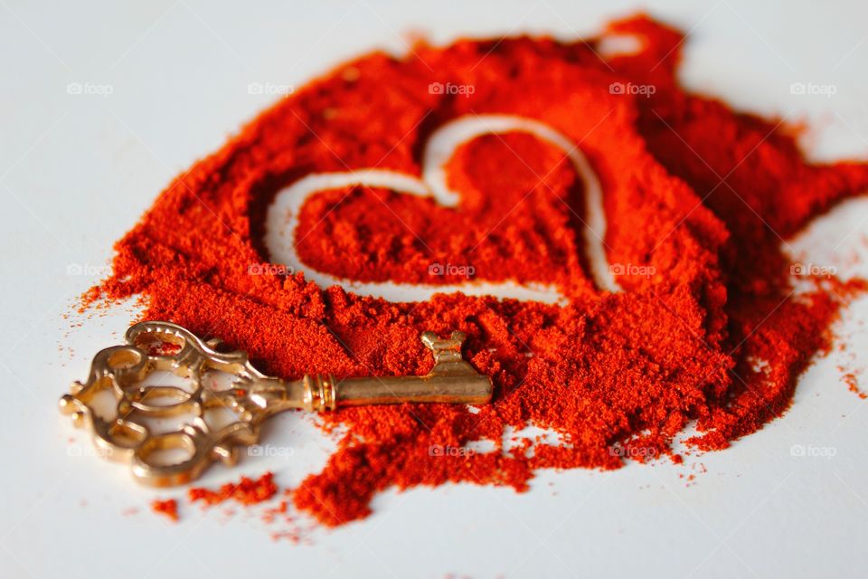 Key with heart shape made of paprika powder