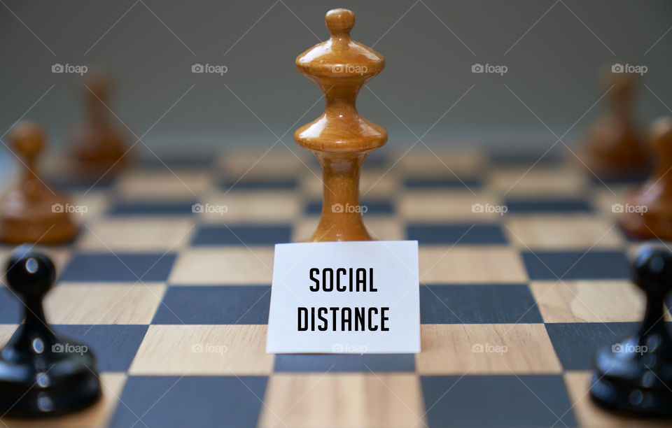 Concept chess pieces expressing social distancing.