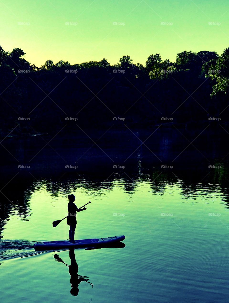 Evening paddle boarding woman
