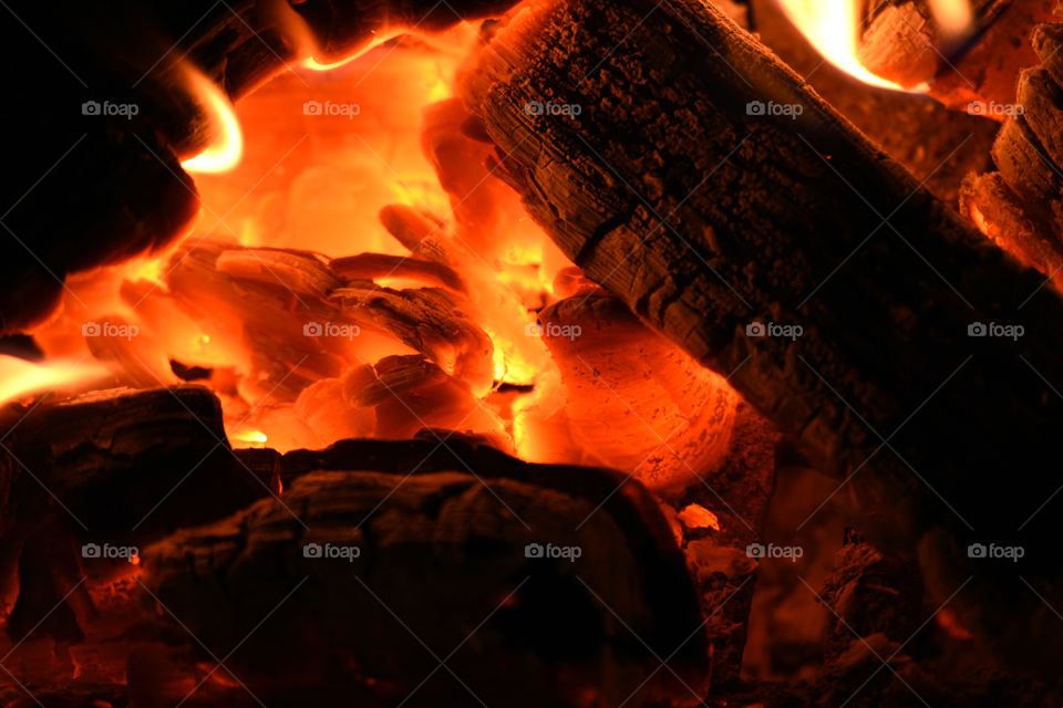 a fire place in close up with burning logs