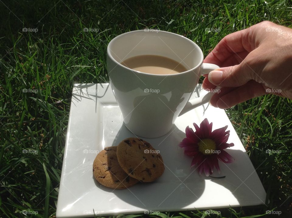 Enjoying a cup of coffee outdoors on a beautiful spring day.