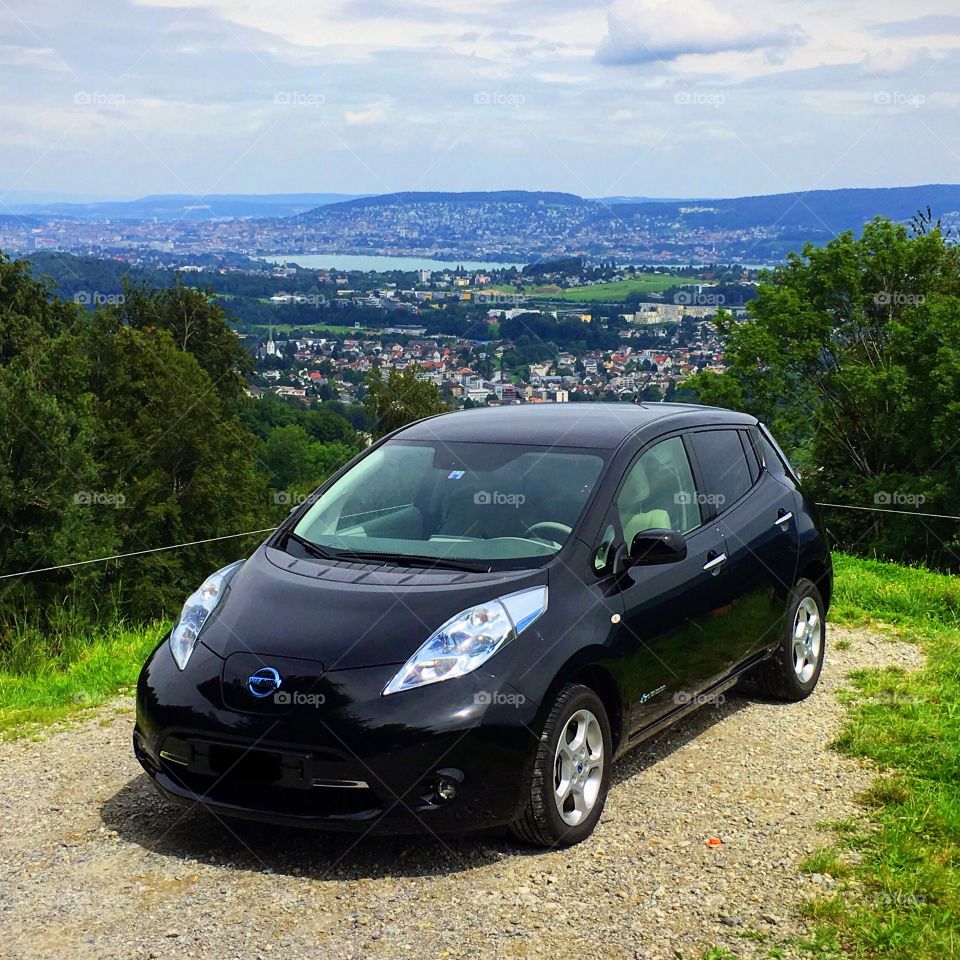 Black Nissan Leaf with beautiful summer background Zürich in Switzerland 