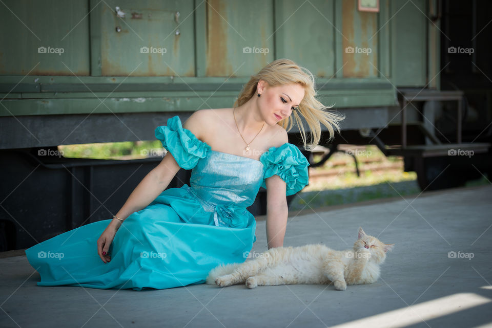 Beautiful woman and cat on the train platform