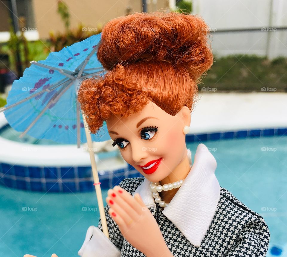 Staying dry with an umbrella and an I Love Lucy Barbie 