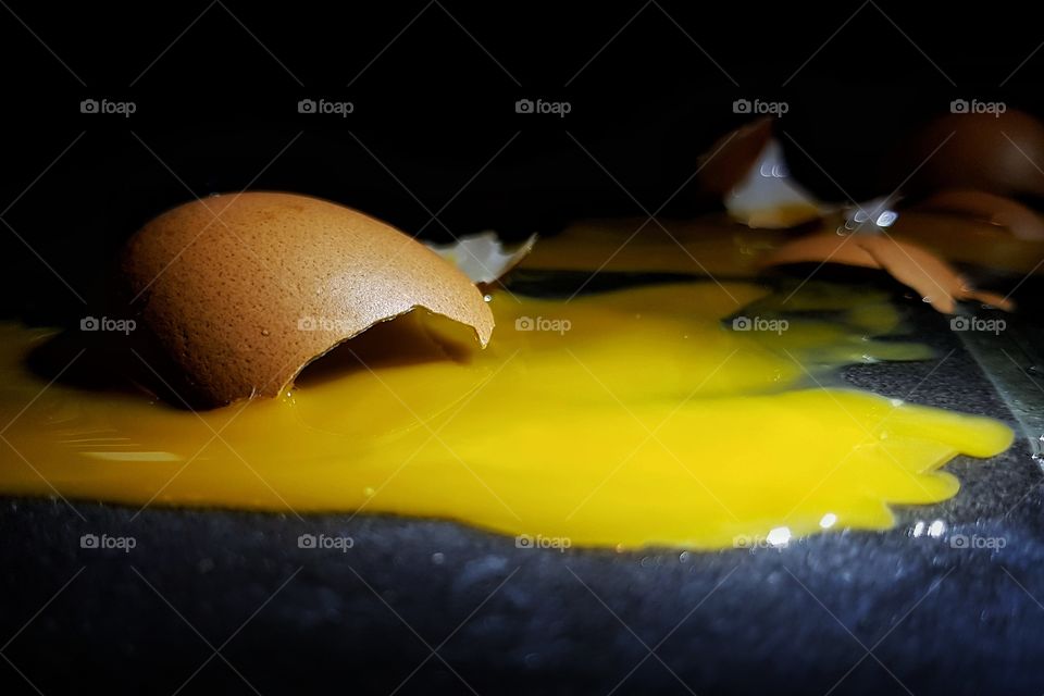 Broken egg. Egg crust and yolk broken on the floor