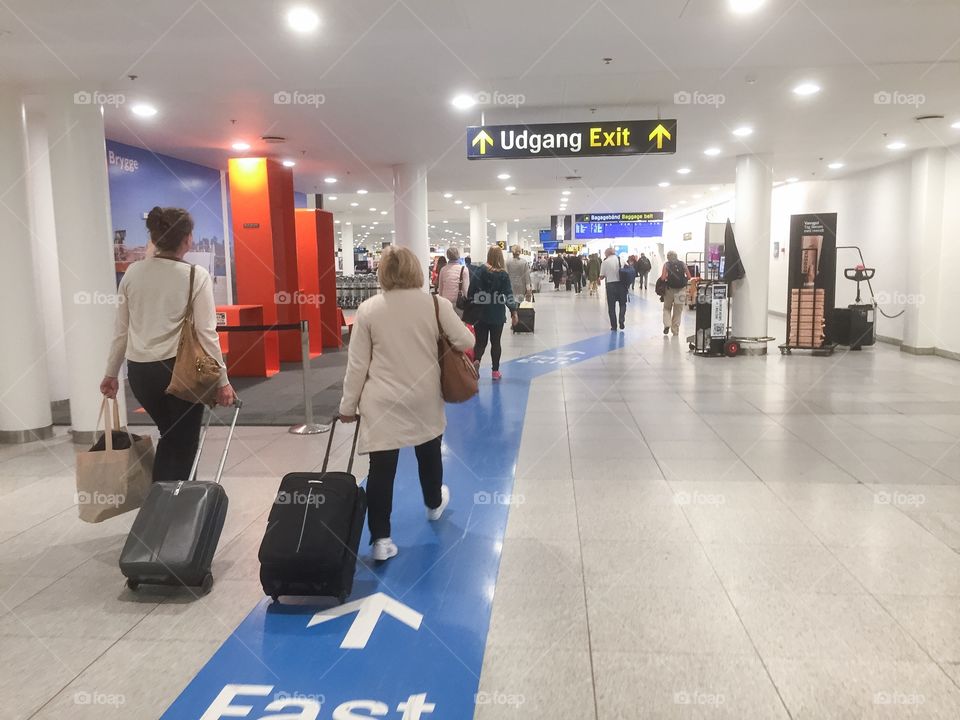 Travelers arriving at Copenhagen airport in Denmark.