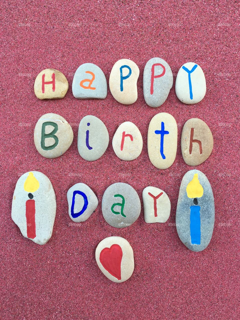 Happy Birthday message on carved and colored stones 