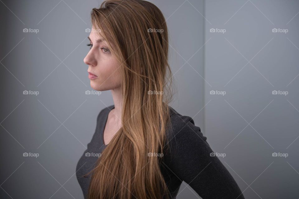 Profile of a millennial woman looking sad and depressed 