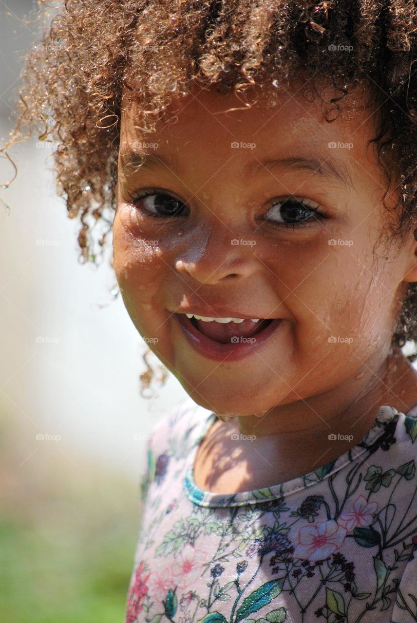 Little toddler of mixed race with curly hair