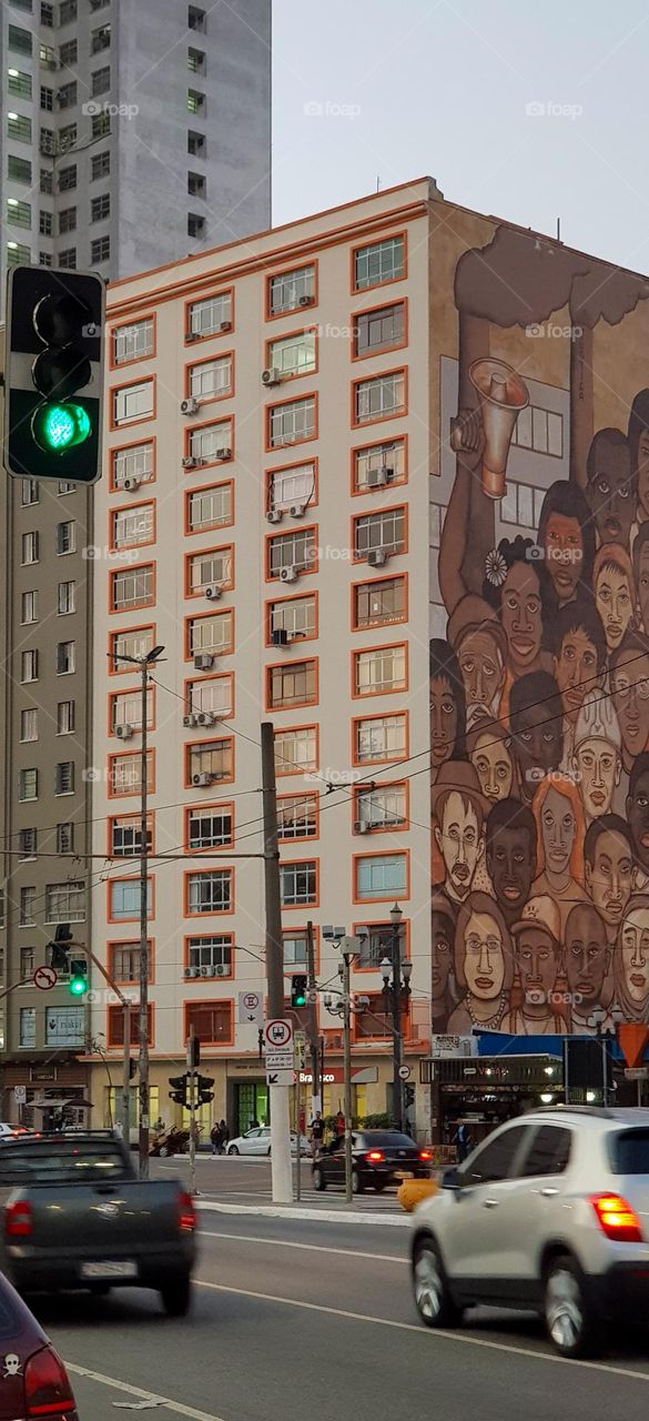 graffitied building - Lit windows at dusk