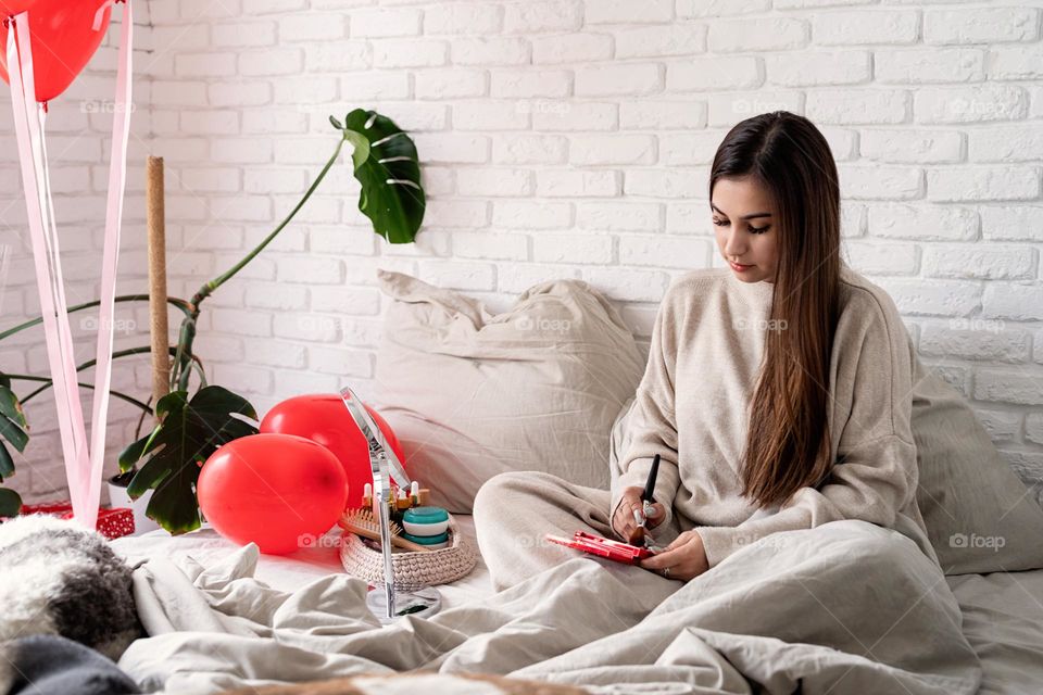 woman using cosmetics at home