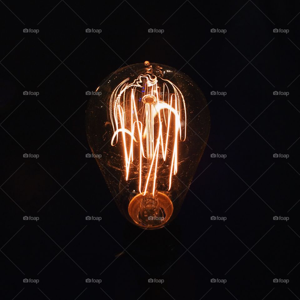 Edison Bulb. Glowing gold Edison bulb