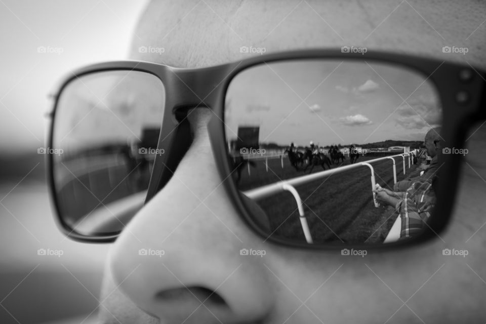 Reflect the race. Horses reflected in lenses.