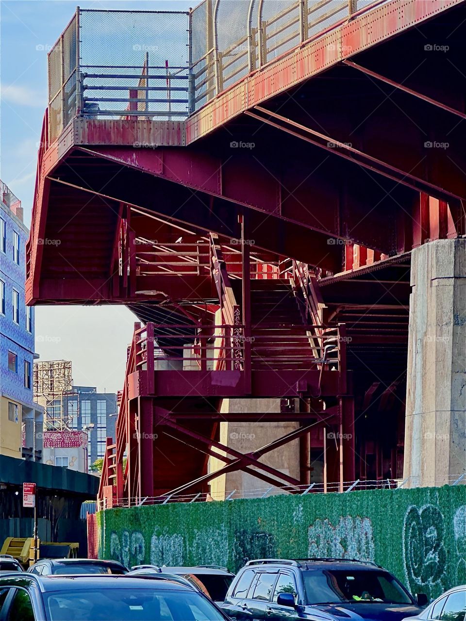 This is the red metal staircase of the „Pulaski Bridge“ at „Newtown Creek“ in „Greenpoint“, Brooklyn with its industrial minimalist aesthetic and „1920s & 30s“ „Bauhaus“ inspired style. 2024. Hypnotic Productions